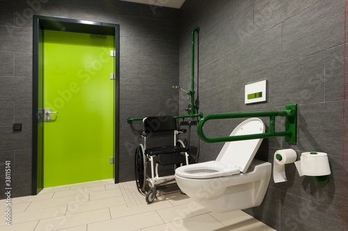 Photo: a toilet for disabled people with green bars, wheelchair a toilet for disabled people with green bars, wheelchair