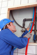 45 years old plumber connecting pipes