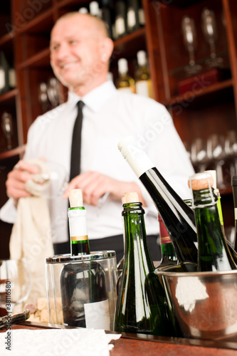Photo: Wine bar bottles waiter in restaurant Wine bar bottles waiter in restaurant