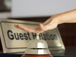 Hand of a woman using a hotel bell
