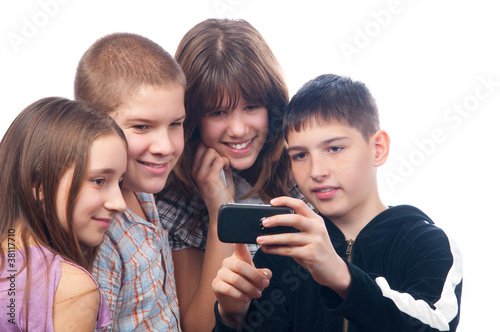 Photo: Teenage boy showing digital content on his mobile phone Teenage boy showing digital content on his mobile phone