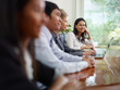 businesspeople talking in meeting room and woman smiling