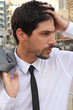 A businessman is holding his head in shock
