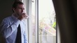 Businessman drinking coffee and looking out of window
