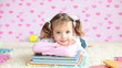 Preschooler with books lying on the floor