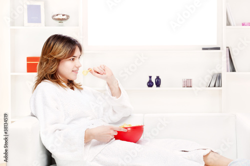 Photo: teenager girl at home eating chips teenager girl at home eating chips