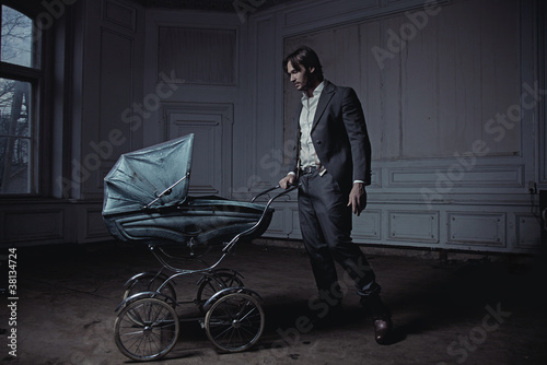 Photo: Fashionable man with a perambulator Fashionable man with a perambulator