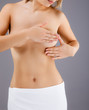 Woman examining her breast Woman examining her breast