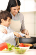 Photo: Mother and little son in the kitchen Mother and little son in the kitchen