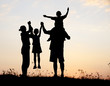 Silhouette, happy children with mother and father