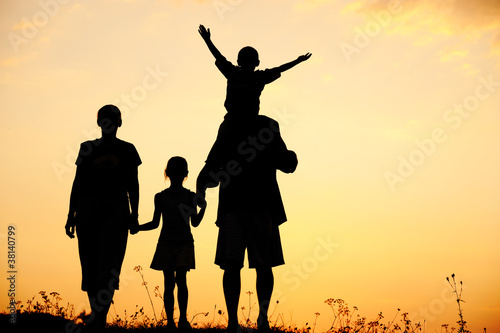 Photo: Children with mother and father, family at sunset Children with mother and father, family at sunset