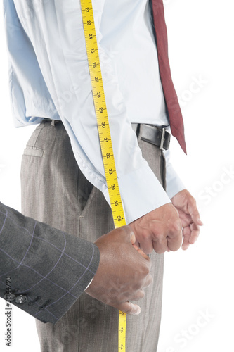 Photo: Tailor measuring shirt's sleeve Tailor measuring shirt's sleeve