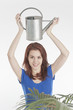 Young woman holding a watering can Young woman holding a watering can