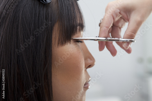 Photo: Close-up view of hairstylist cutting hair Close-up view of hairstylist cutting hair