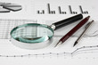 magnifying glass and working paper