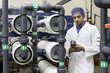 Worker holding an equipment in bottling plant