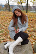 A young girl with a book in the park