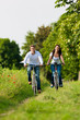 Man and woman cycling in summer