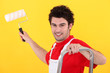 A painter holding a paint roller