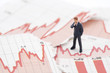 Financial crisis. Figure of businessman on financial charts