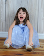 expressive little girl sitting on floor