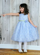 happy little girl in beautiful blue dress pointing