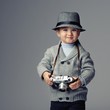 Photo: Baby boy with retro camera. Baby boy with retro camera.