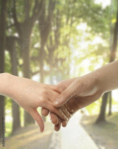 Photo: Couple hands closed together outdoors Couple hands closed together outdoors