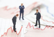 Financial crisis. Figures of businessman on financial charts