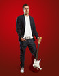stylish man with guitar looking at camera