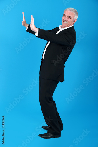 Photo: Man straining to push a heavy object Man straining to push a heavy object
