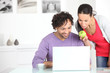 Couple using a laptop at home