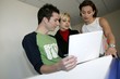 Creative team working around a laptop