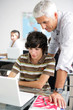 Teacher helping male pupil