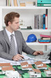 Young architect sitting at his desk