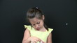 Child blowing bubbles closeup