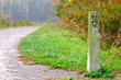 Old stone mile marker along a jogging trail
