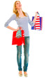 Photo: Full length portrait of smiling teen girl with shopping bags Full length portrait of smiling teen girl with shopping bags