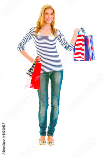 Photo: Full length portrait of happy teen girl with shopping bags Full length portrait of happy teen girl with shopping bags