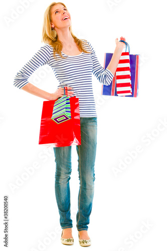 Photo: Full length portrait of smiling teen girl with shopping bags Full length portrait of smiling teen girl with shopping bags