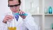Female scientist mixing chemicals in erlenmeyer flask