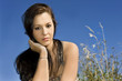 Photo: Beautiful young woman against blue sky Beautiful young woman against blue sky