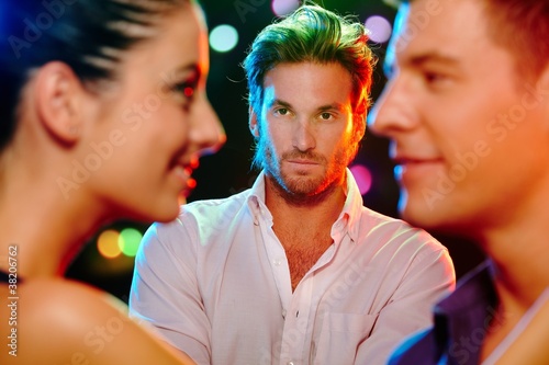 Foto: Jealous man looking at flirting couple Jealous man looking at flirting couple