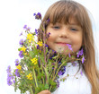 Little girl with wildflower