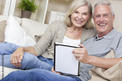 Photo: Happy Senior Man & Woman Couple Using Tablet Computer Happy Senior Man & Woman Couple Using Tablet Computer