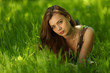 brunette lying on green grass