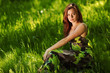 brunette sitting on green grass