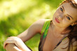 brunette sitting on green grass