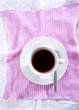 Photo: Cup of black coffee on a pink placemat Cup of black coffee on a pink placemat