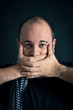 Dumb Man portrait on dark background.